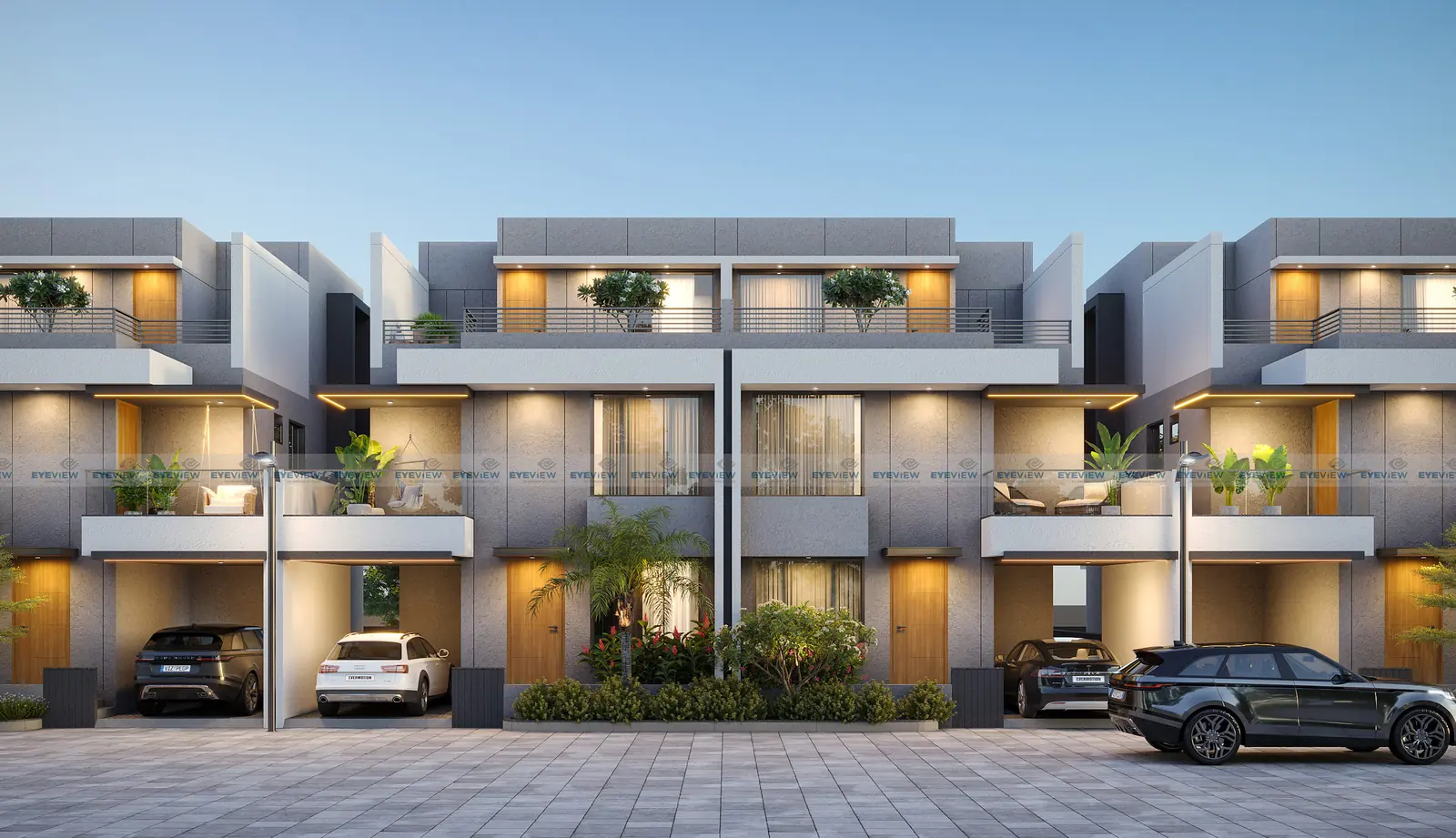 Dusk render of Shantam Bungalows: a row of two-storey grey houses with lit balconies